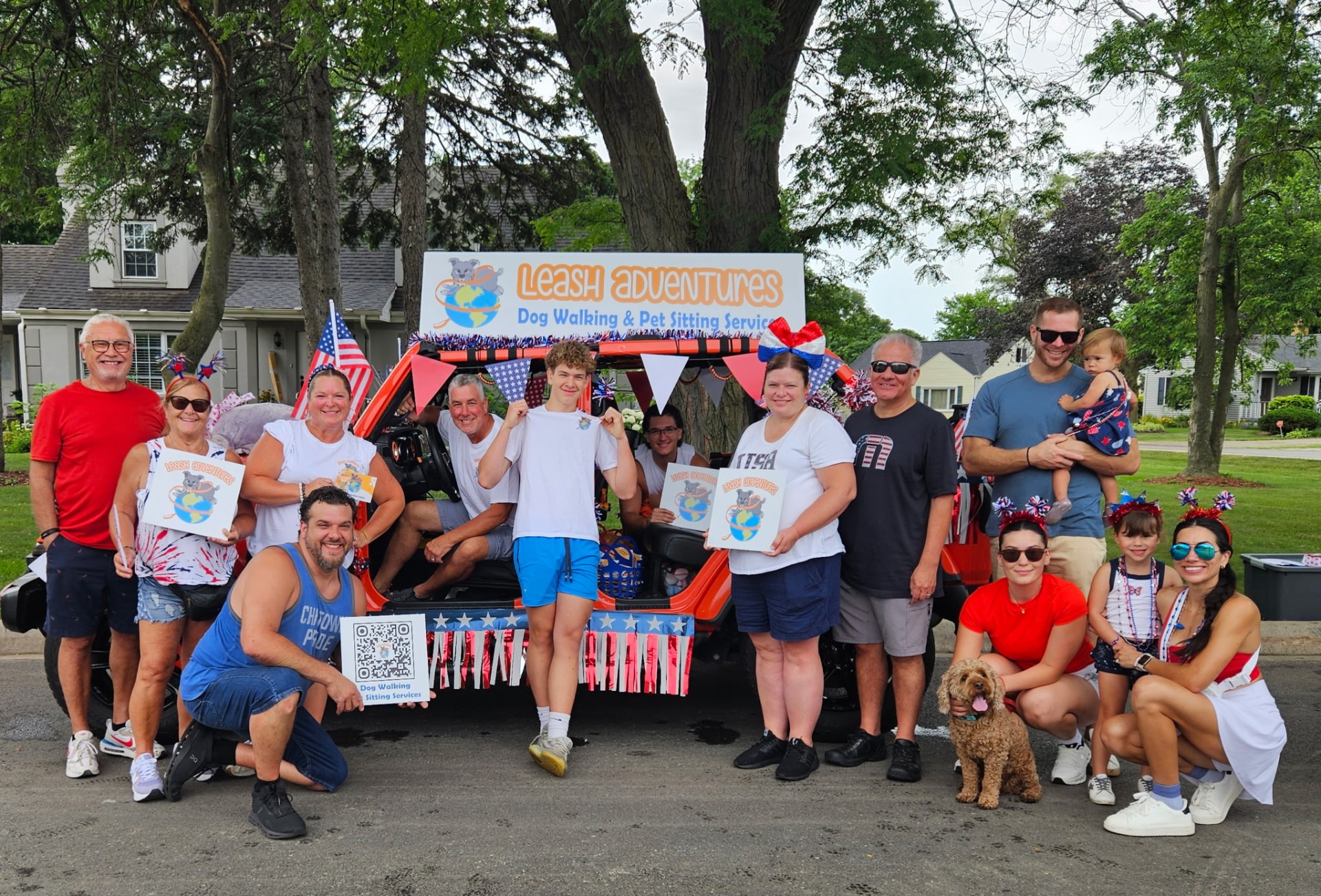 Leash Adventures team and family posing with the decorated Jeep at the 4th of July parade in Elmhurst, IL